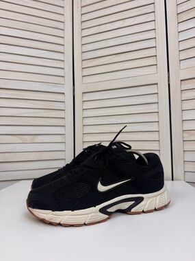 Nike Kids Black Sneakers with White Swoosh and Cream Midsole